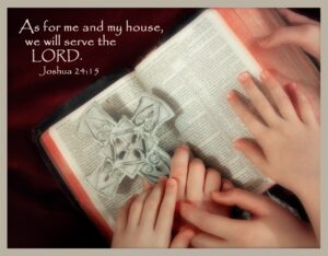 Bailey, Cole and Madison Dietrich holding a cross with their hands on a Bible with it open to Joshua 24:15.