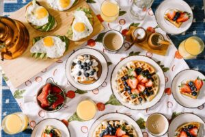 Breakfast, waffles, blueberries, strawberries, coffee, cream,Photo by Rachel Park on Unsplash 