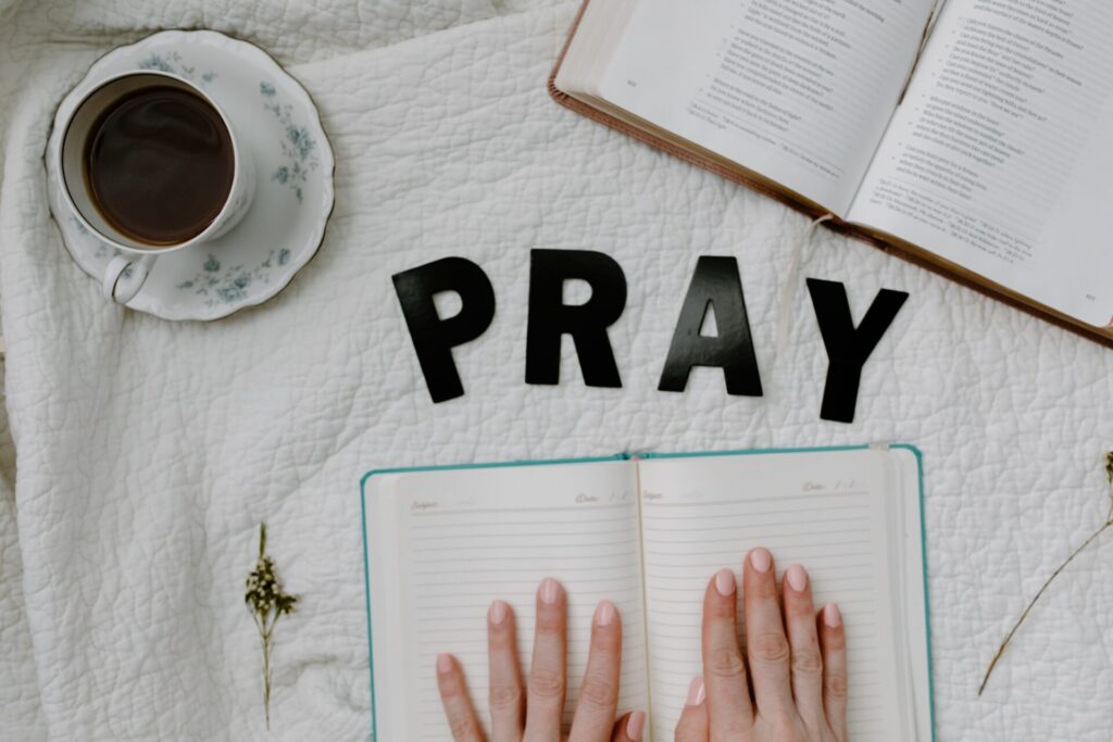 Pray, hands on bible