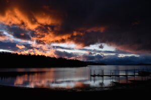 Hedge of Protection, body of water under cloudy sky during sunset